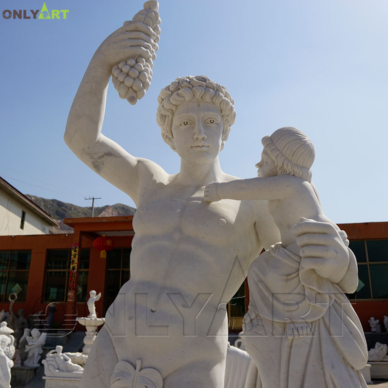 man holding grape statue